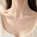 The 40 cm and 50 cm box chains worn together to show where each length sits