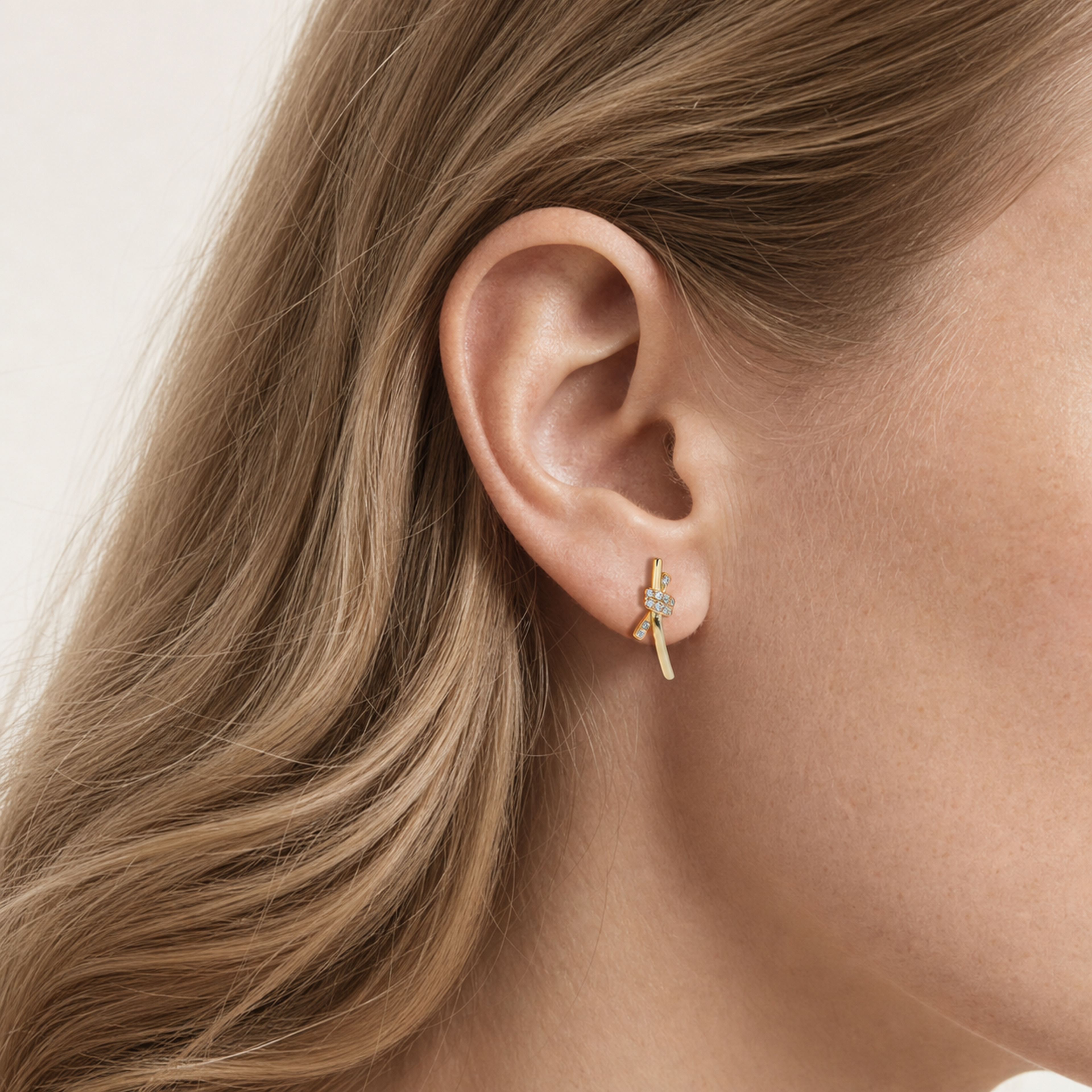 Sterling Silver Pave Zirconia Knot Stud Earrings worn on the ear