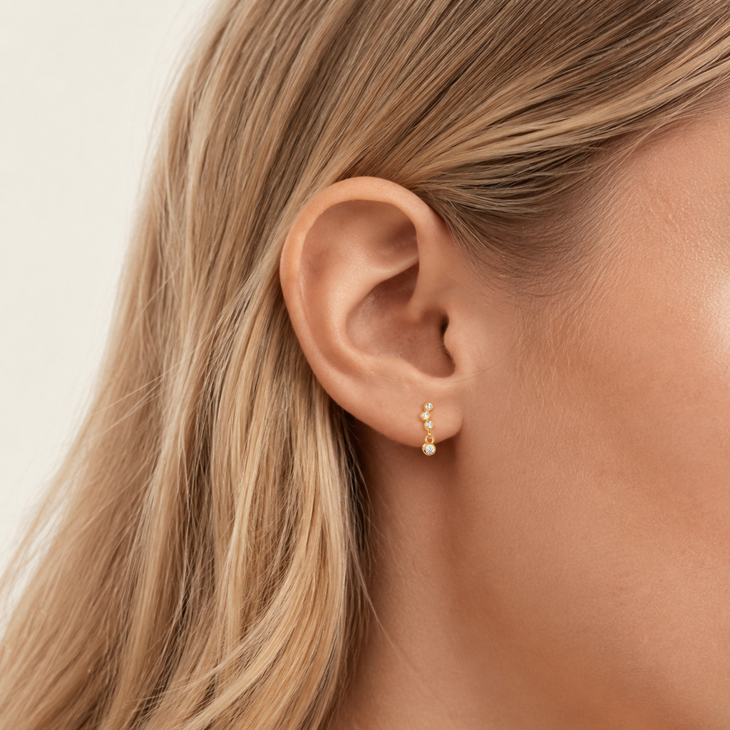 Sterling Silver Dainty Cubic Zirconia Stud Earrings worn on the ear