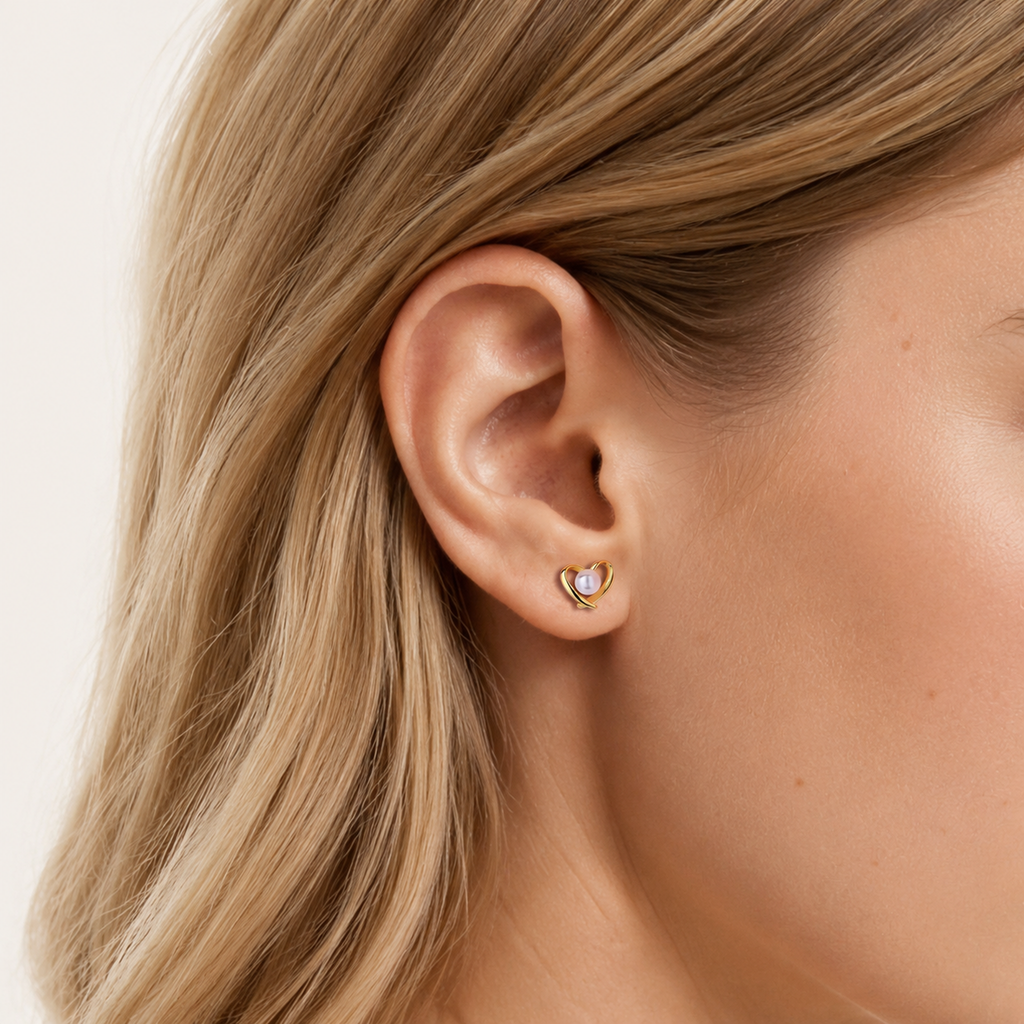 Sterling Silver Pearl Heart Stud Earrings worn on the ear