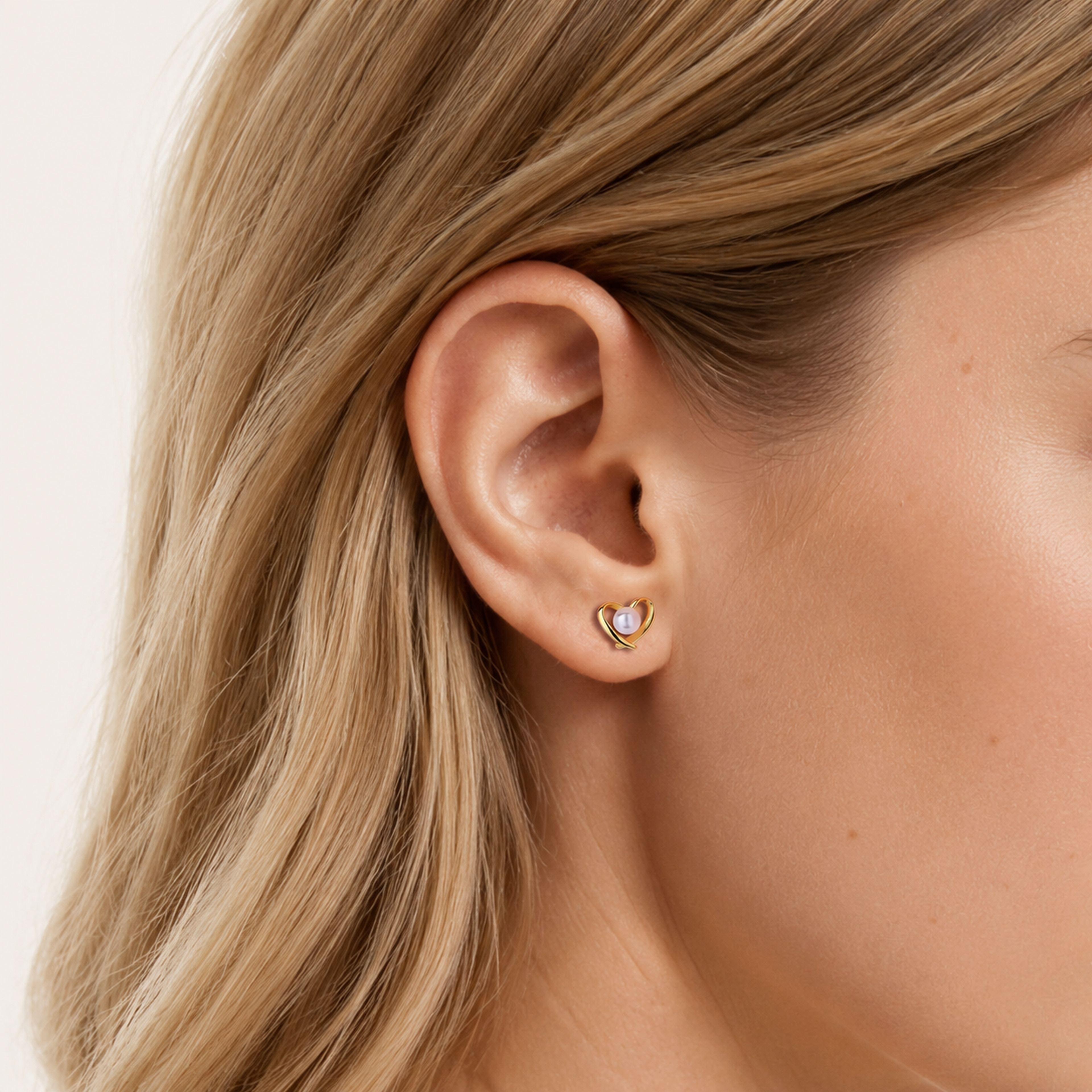 Sterling Silver Pearl Heart Stud Earrings worn on the ear