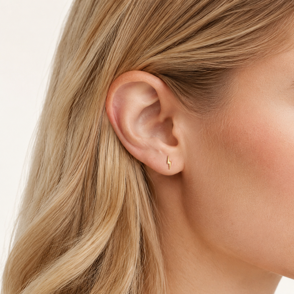 Sterling Silver Lightning Bolt Stud Earrings worn on the ear