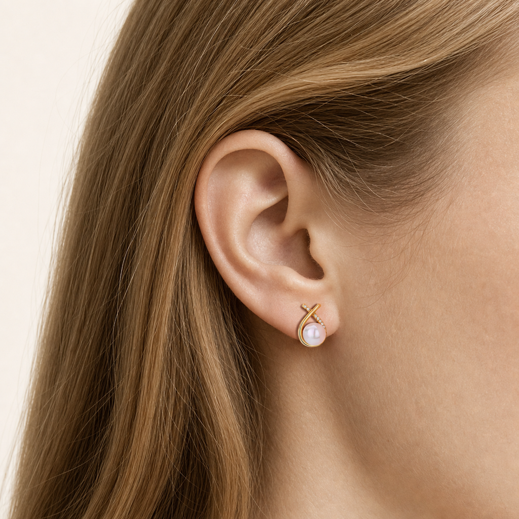 Sterling Silver Pearl And Crossover Zirconia Stud Earrings worn on the ear