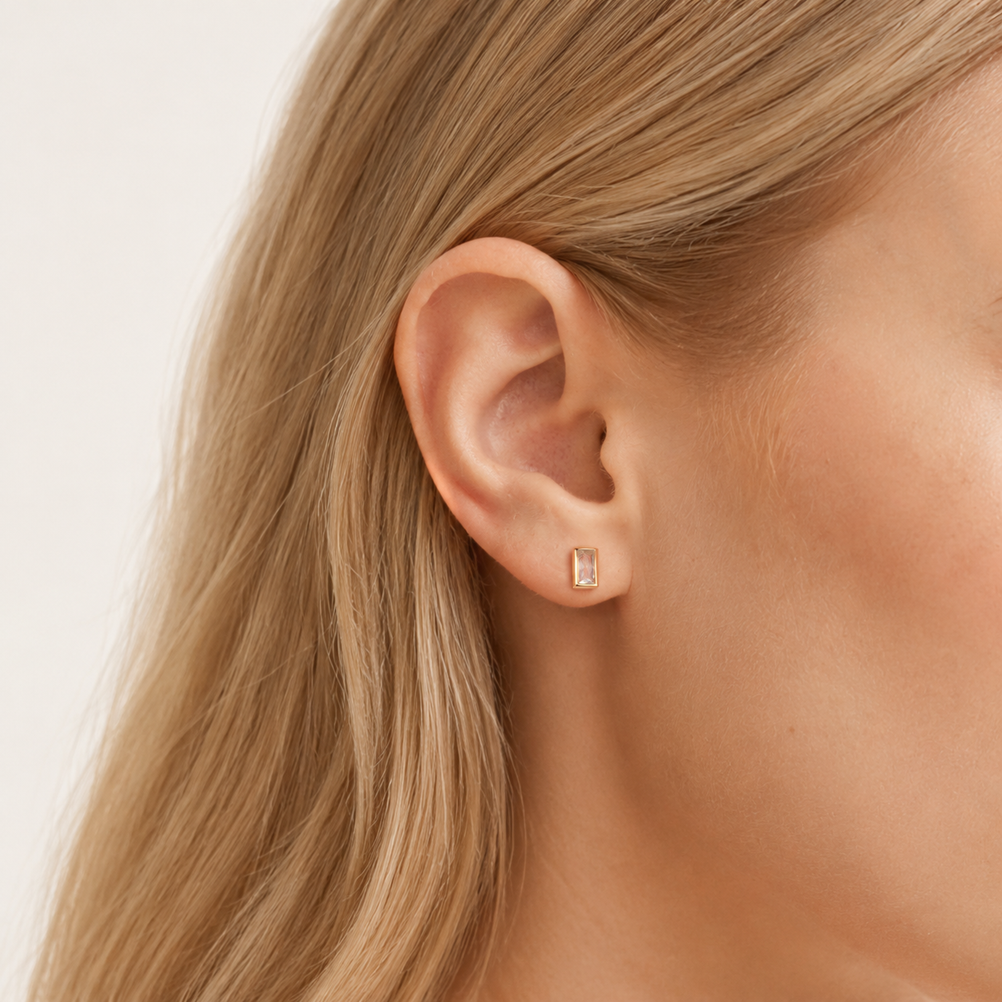 Sterling Silver Square Zirconia Stud Earrings worn on the ear