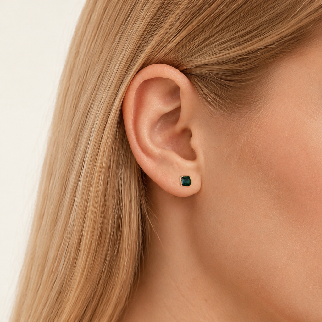 Sterling Silver Square Emerald-Green Zirconia Stud Earrings worn on the ear