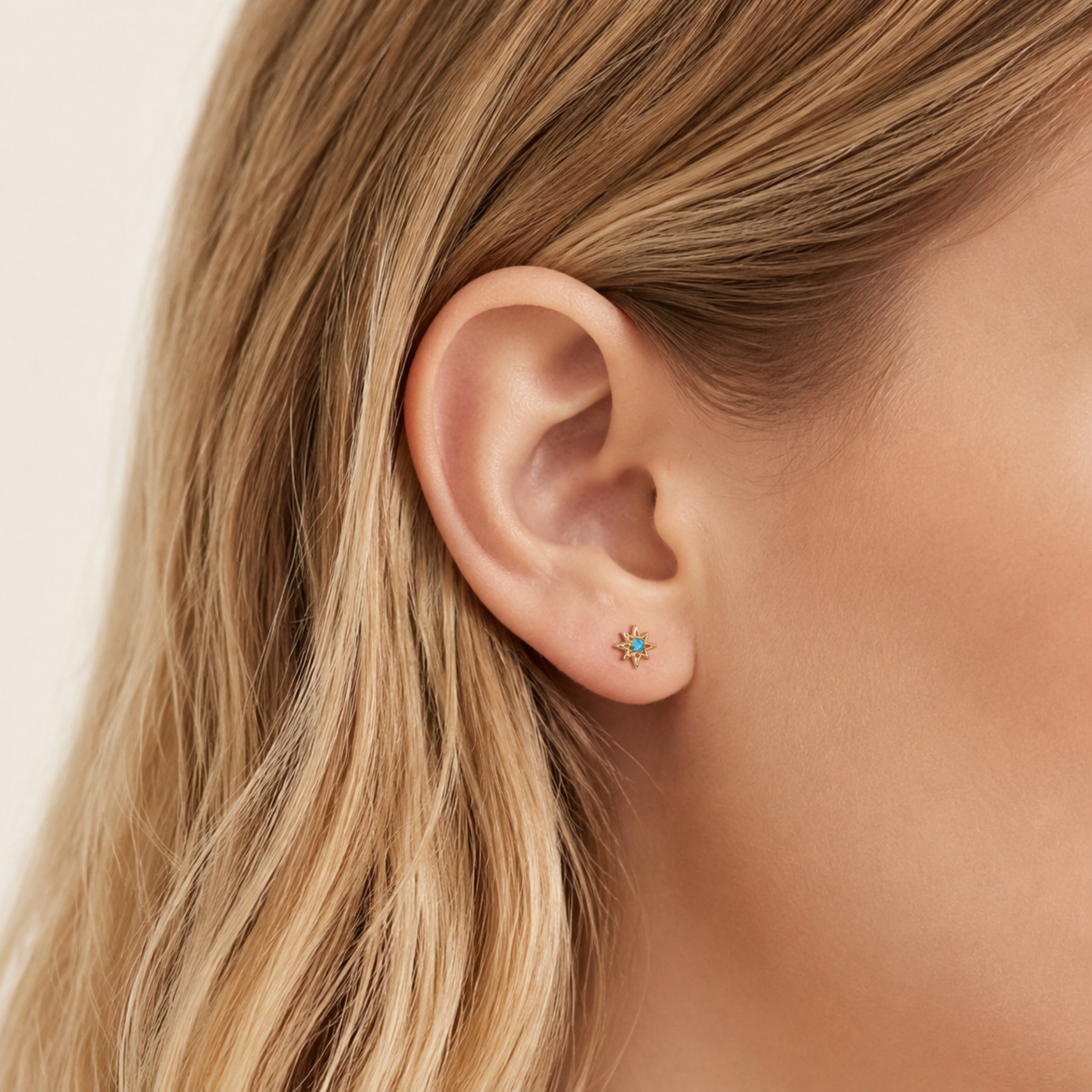 Sterling Silver Opal Eight-Point Star Stud Earrings worn on the ear