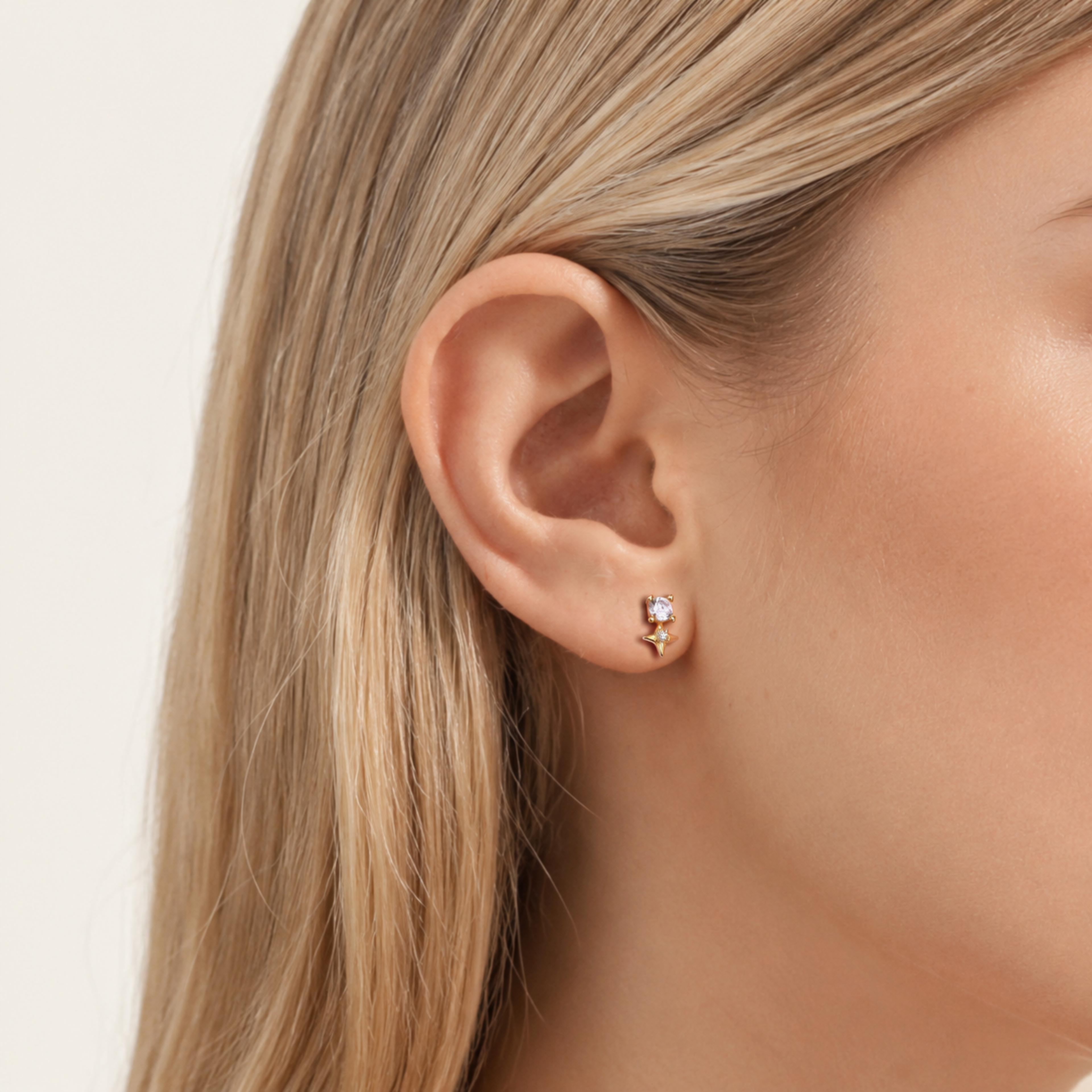 Sterling Silver Four-Point Star Zirconia Flat Back Earrings worn on the ear
