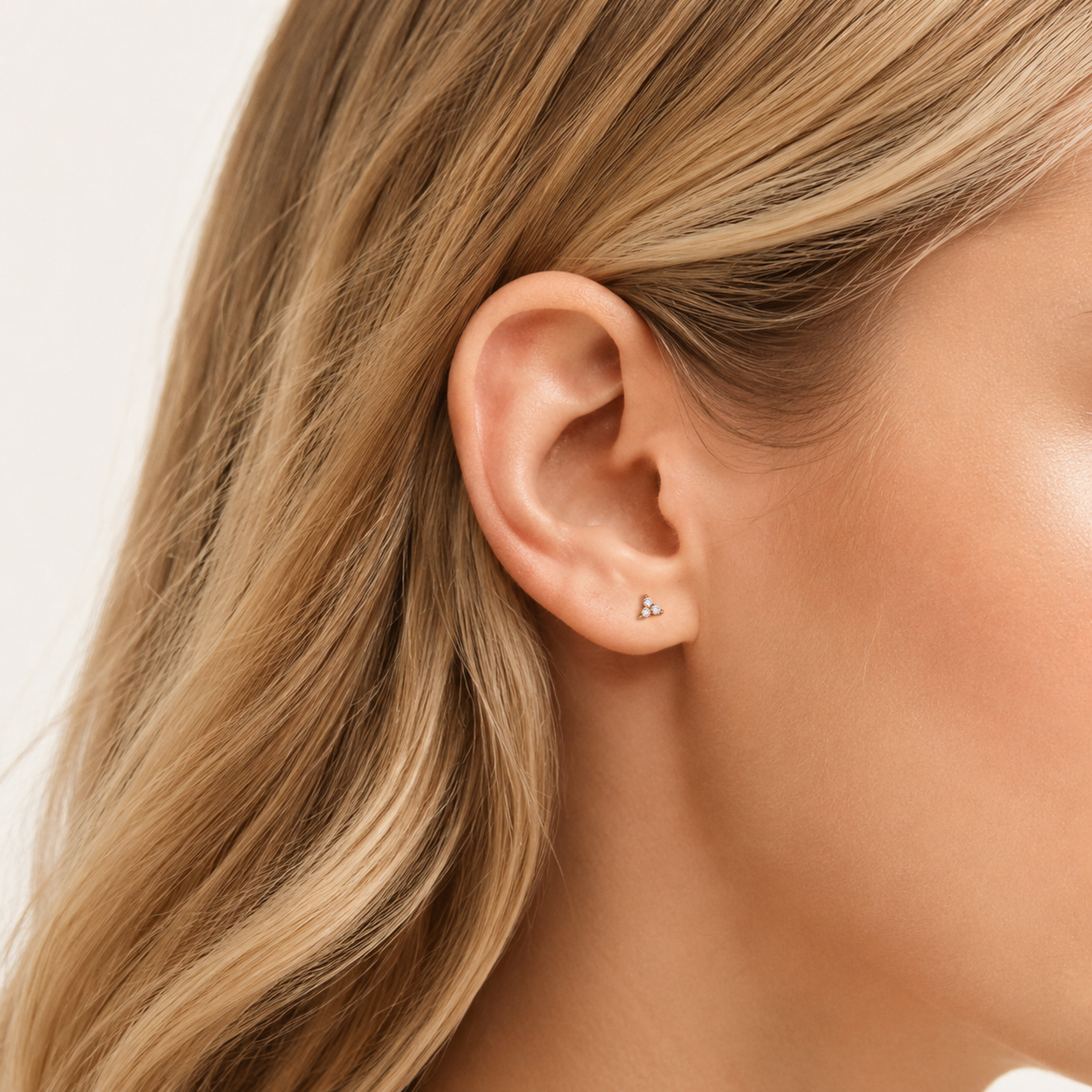 Sterling Silver Three-Stone Zirconia Cartilage Flat Back Earrings worn on the ear