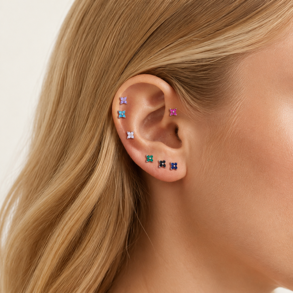 Sterling Silver Four-Petal Flower Stud Earrings worn on the ear