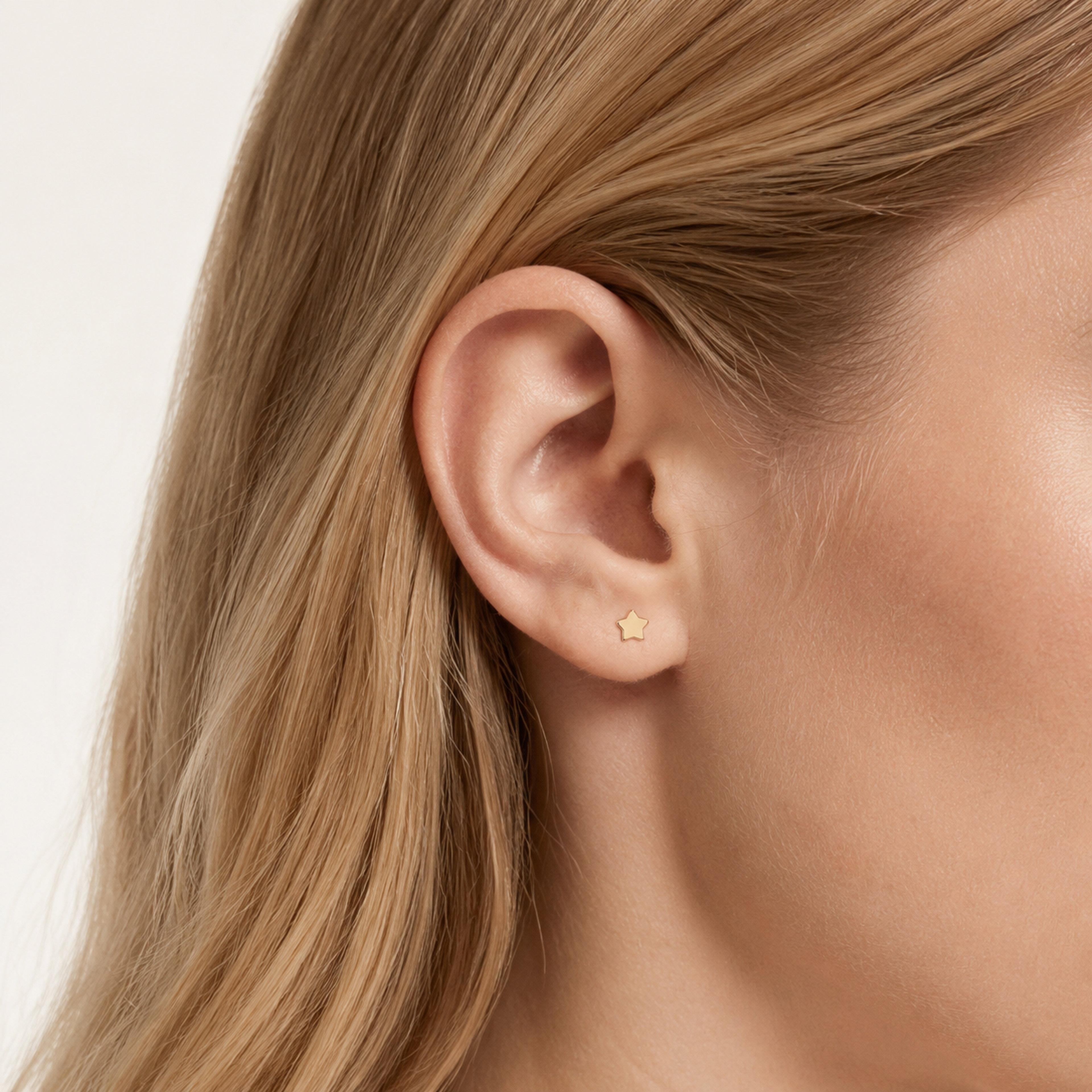 Sterling Silver Polished Five-Point Star Flat Back Earrings worn on the ear