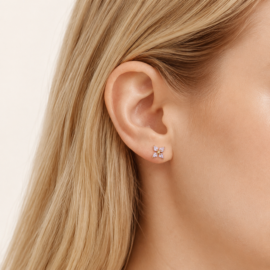 Sterling Silver Four-Point Star Zirconia Flat Back Earrings worn on the ear