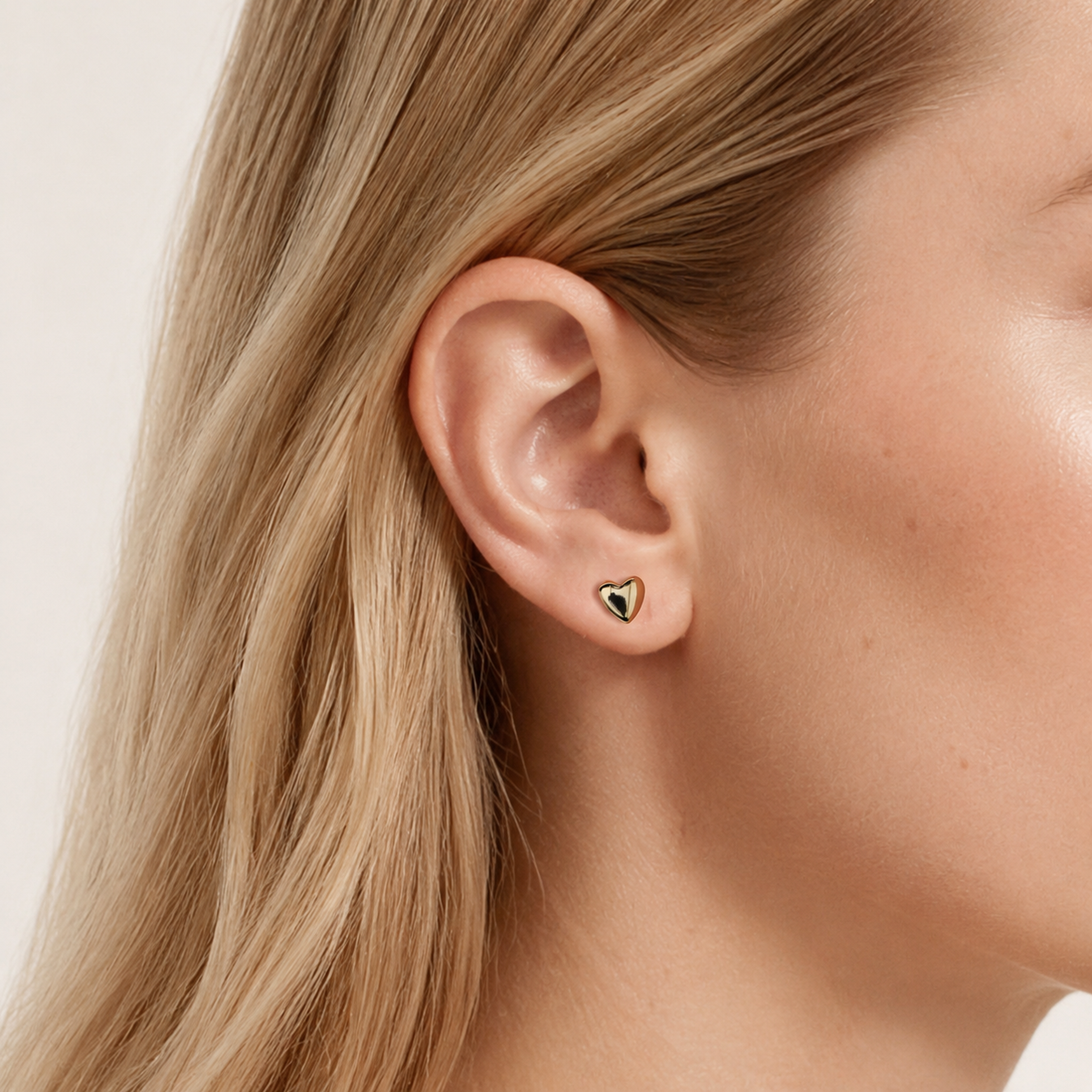 Sterling Silver Polished Heart Stud Earrings worn on the ear