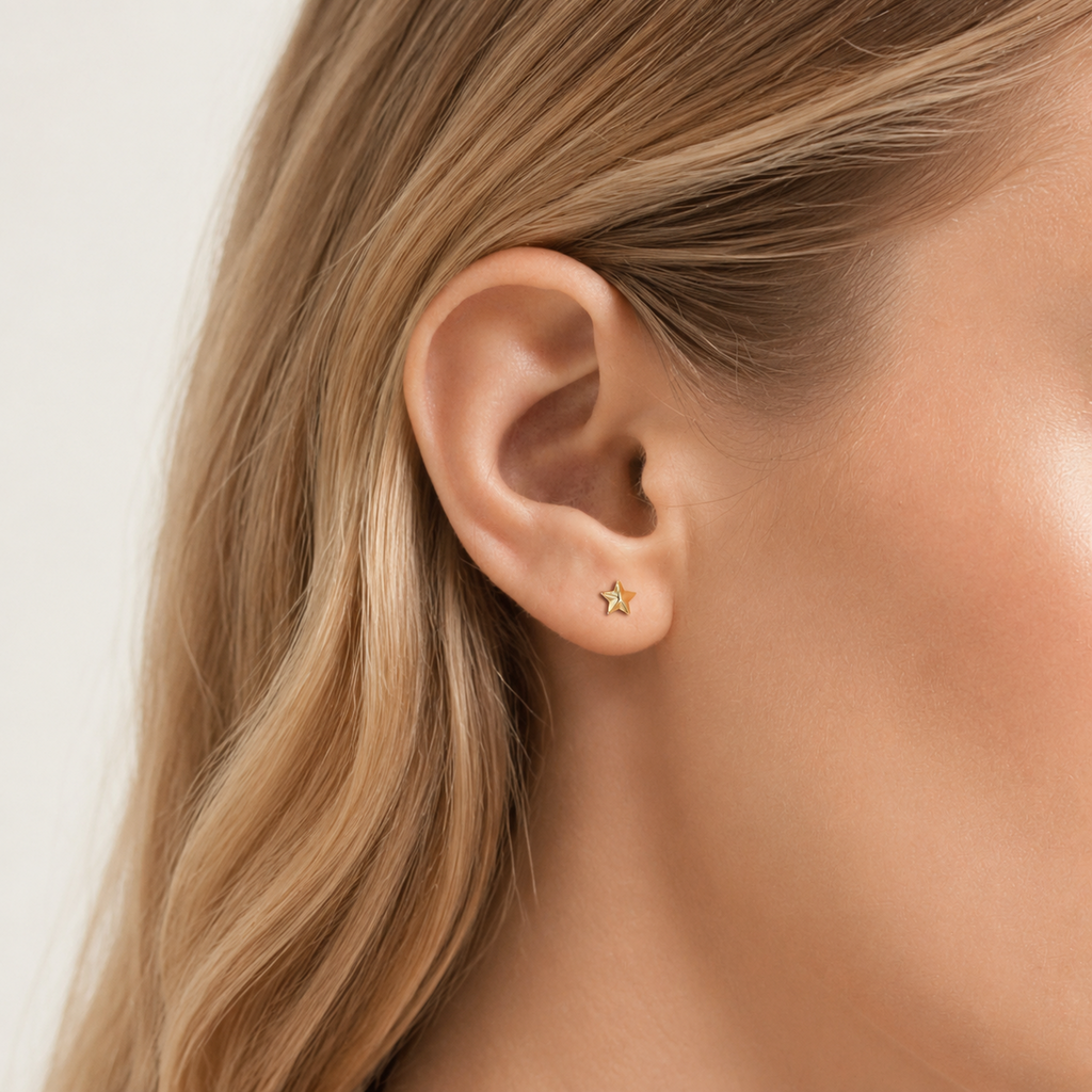 Sterling Silver Polished Five-Point Star Stud Earrings worn on the ear