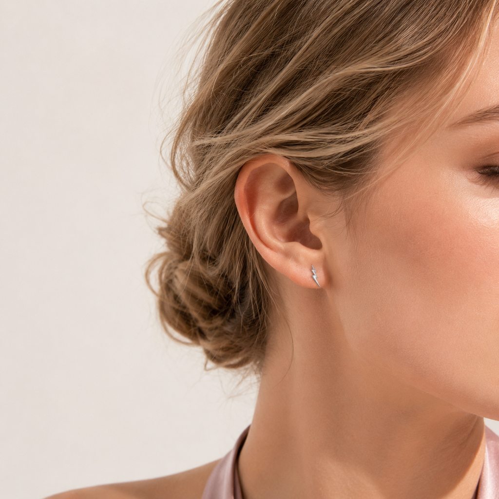 Sterling Silver Lightning Bolt Stud Earrings worn on the ear