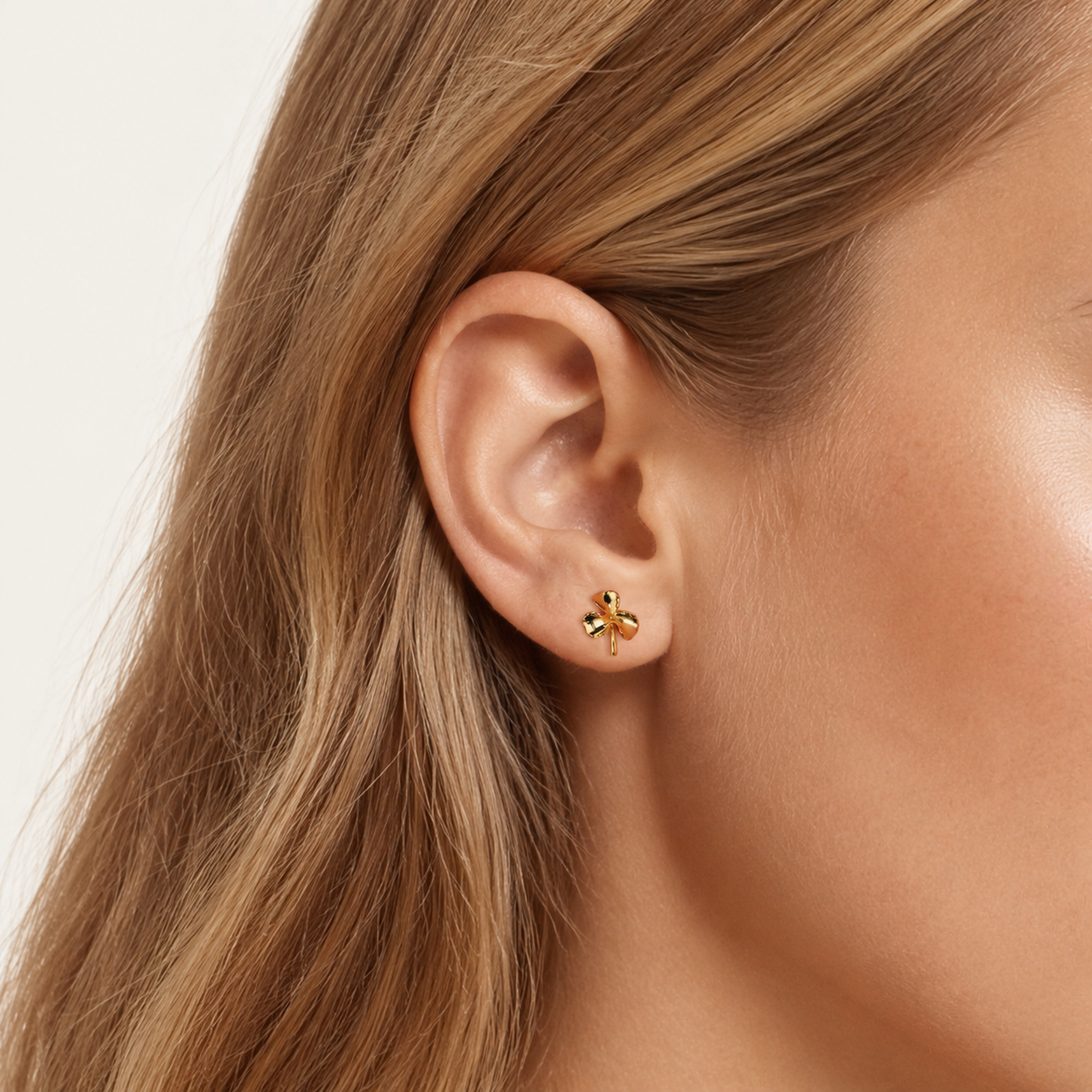 Sterling Silver Three-Leaf Clover Stud Earrings worn on the ear