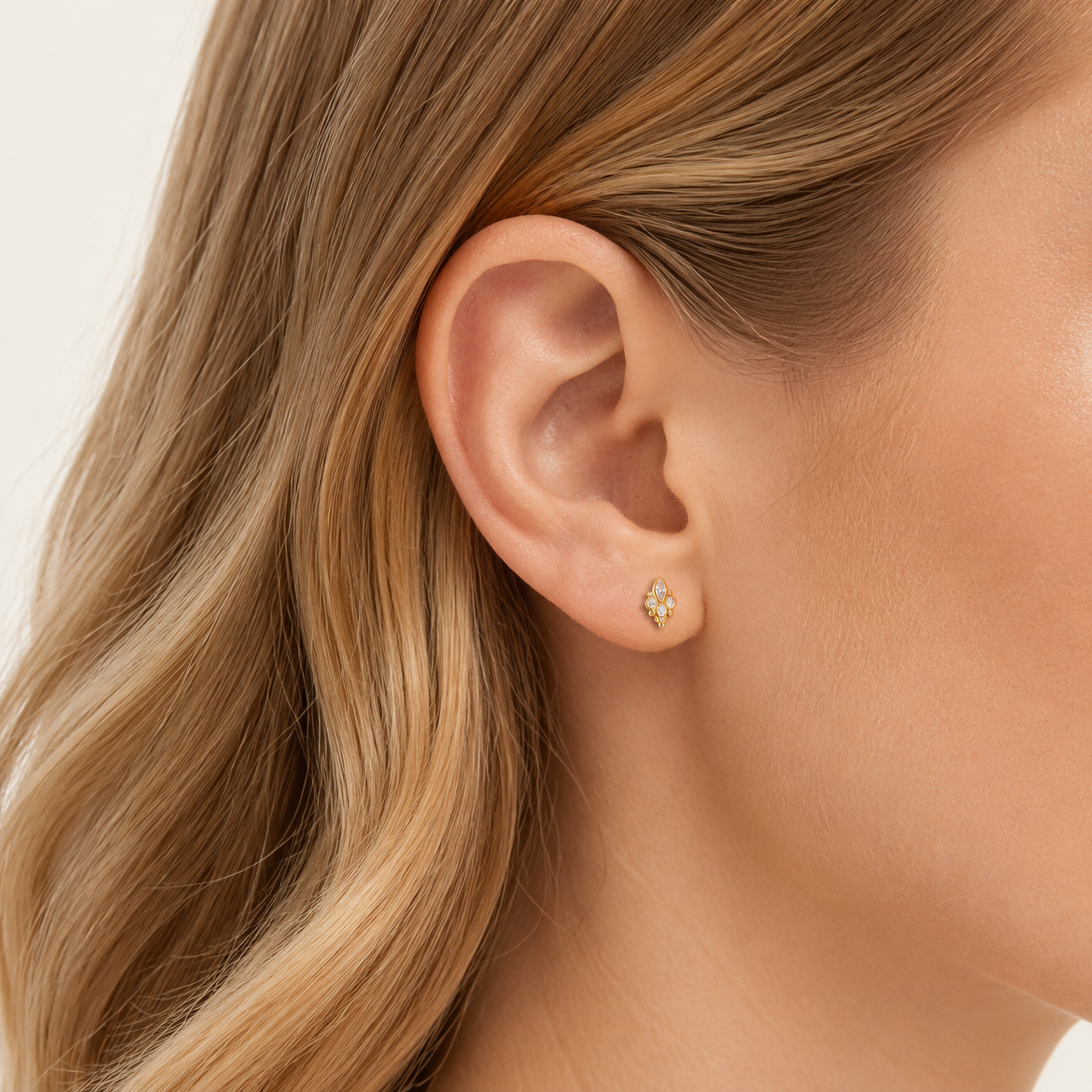 Sterling Silver Paw Print Stud Earrings worn on the ear