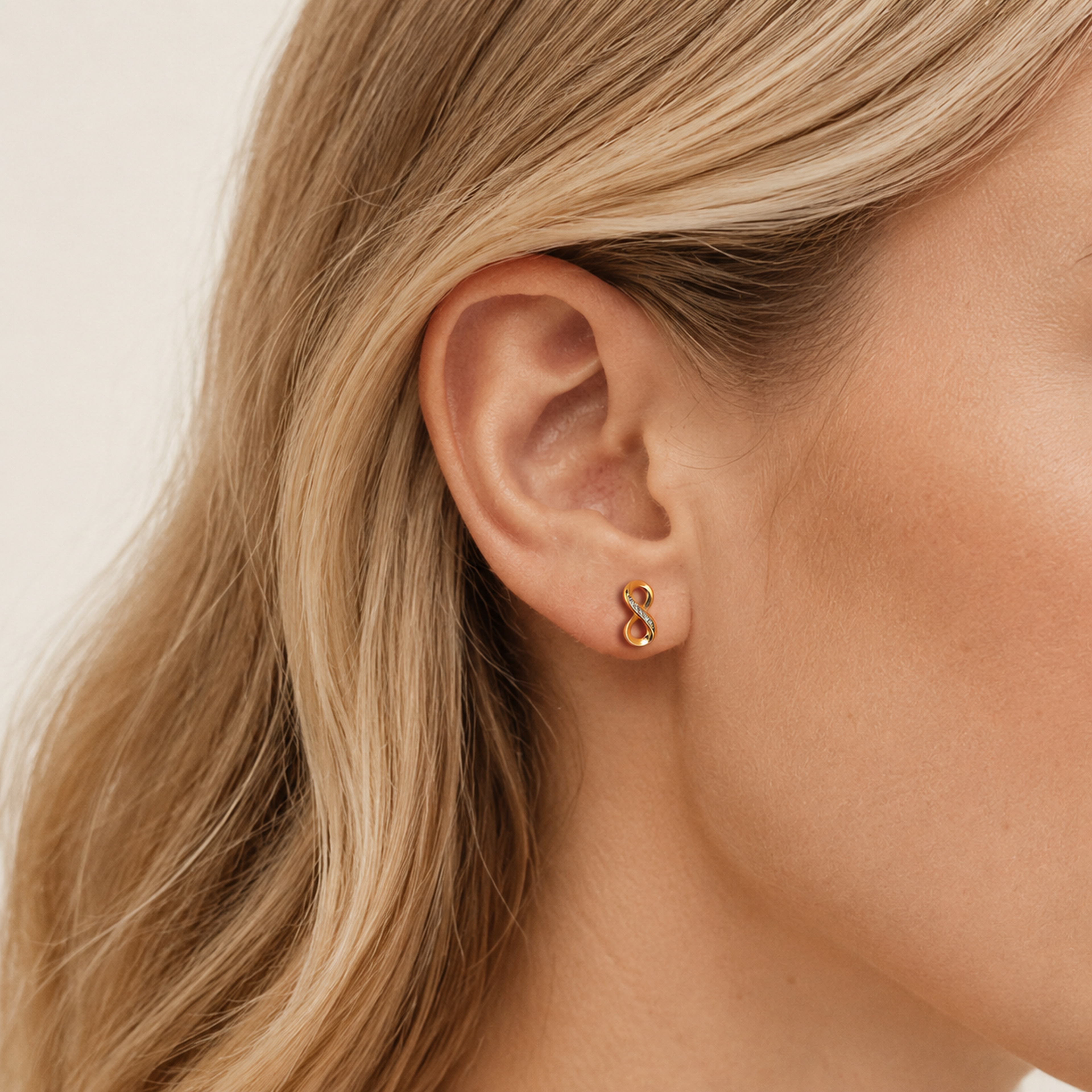 Sterling Silver Figure-Eight Zirconia Stud Earrings worn on the ear