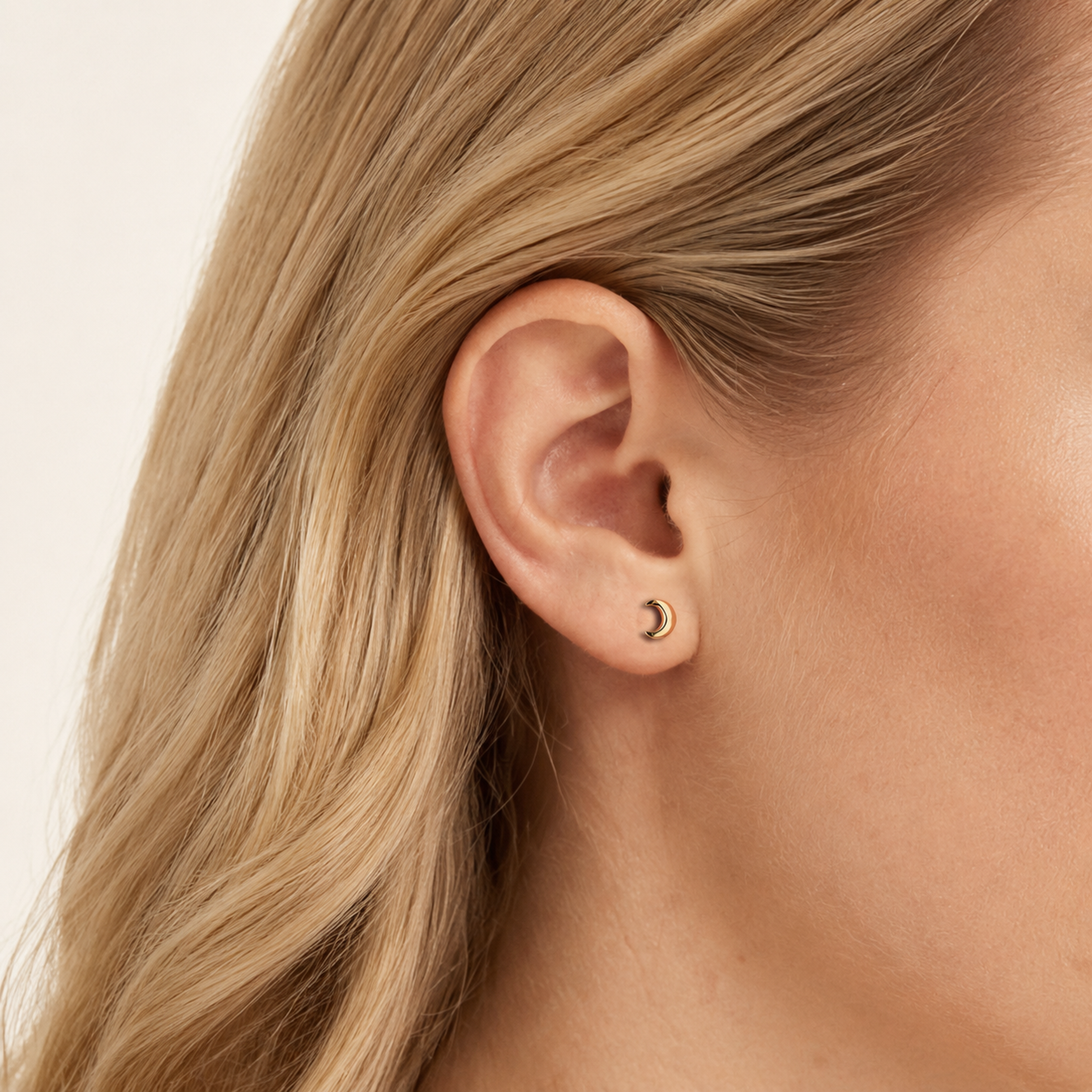 Sterling Silver Polished Moon Stud Earrings worn on the ear