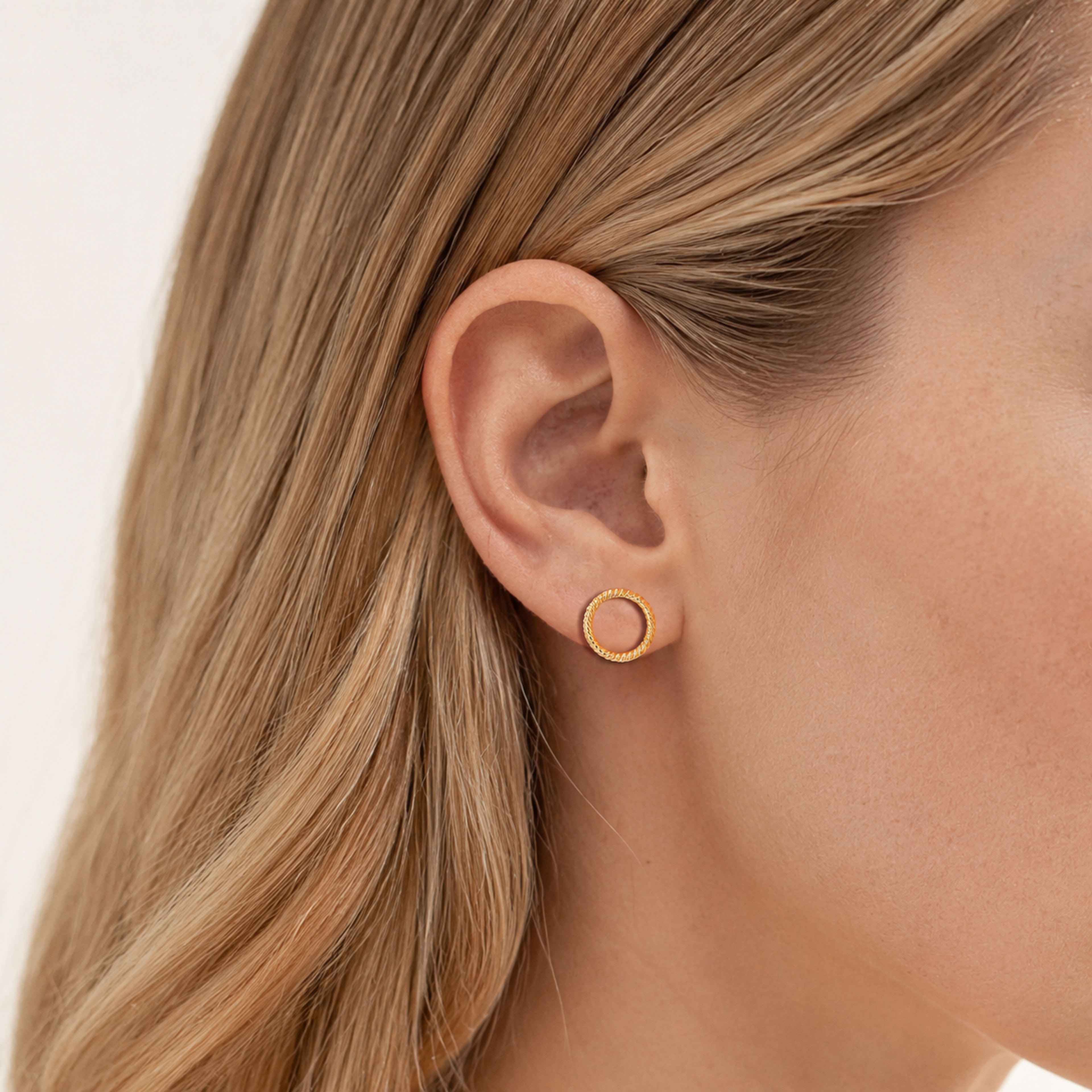 Sterling Silver Polished Twist Stud Earrings worn on the ear