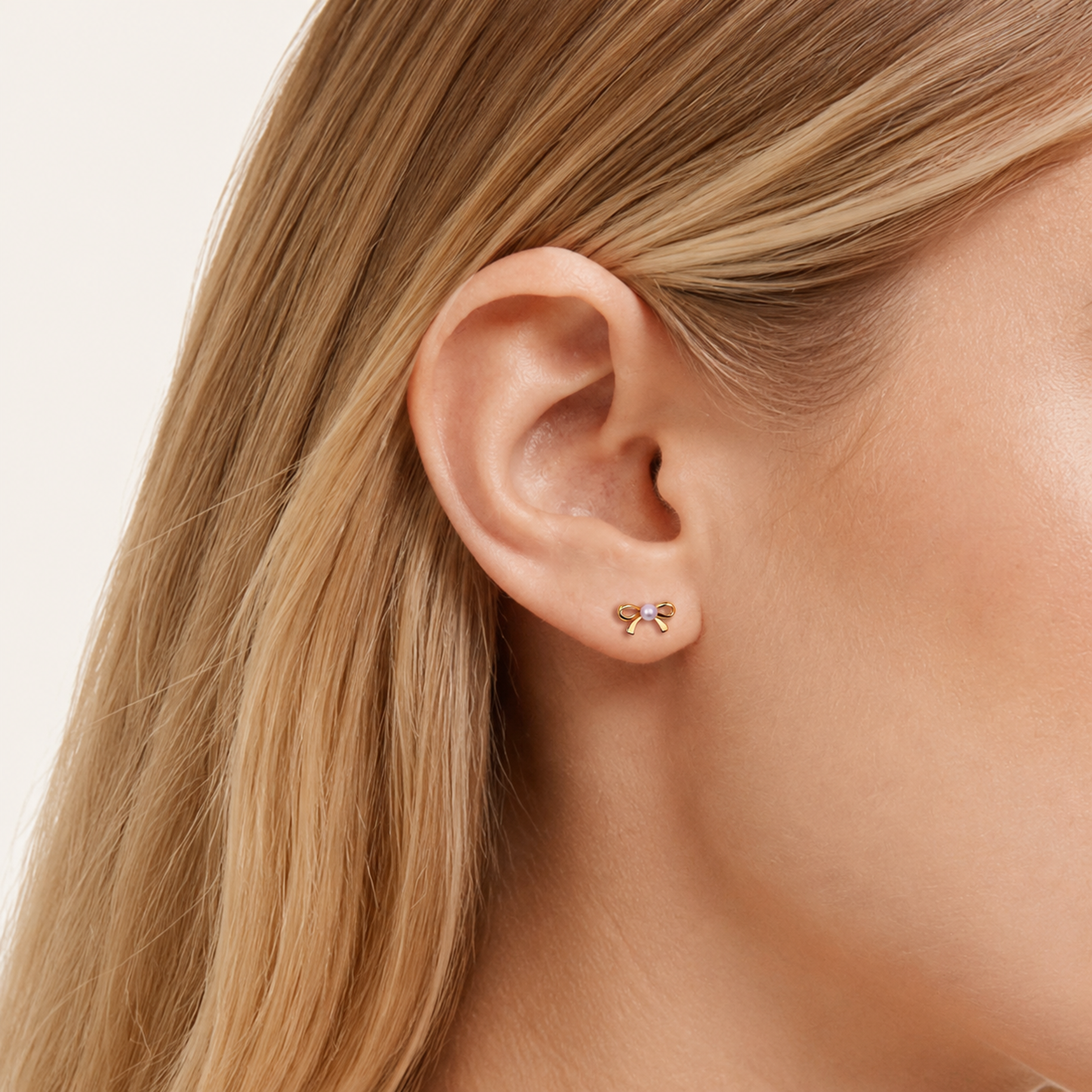 Sterling Silver Pearl Bow Flat Back Earrings worn on the ear