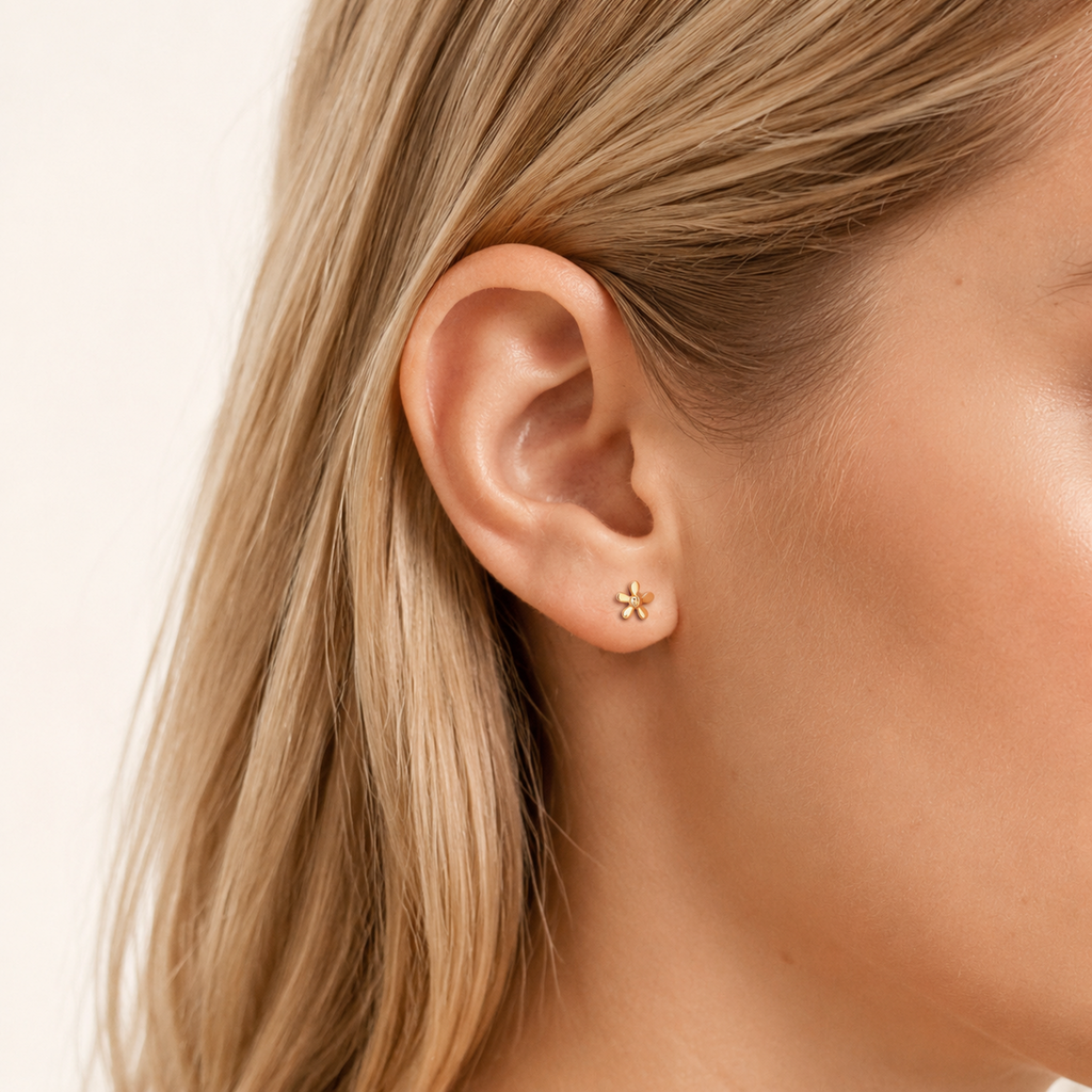 Sterling Silver Mini Flower Stud Earrings worn on the ear