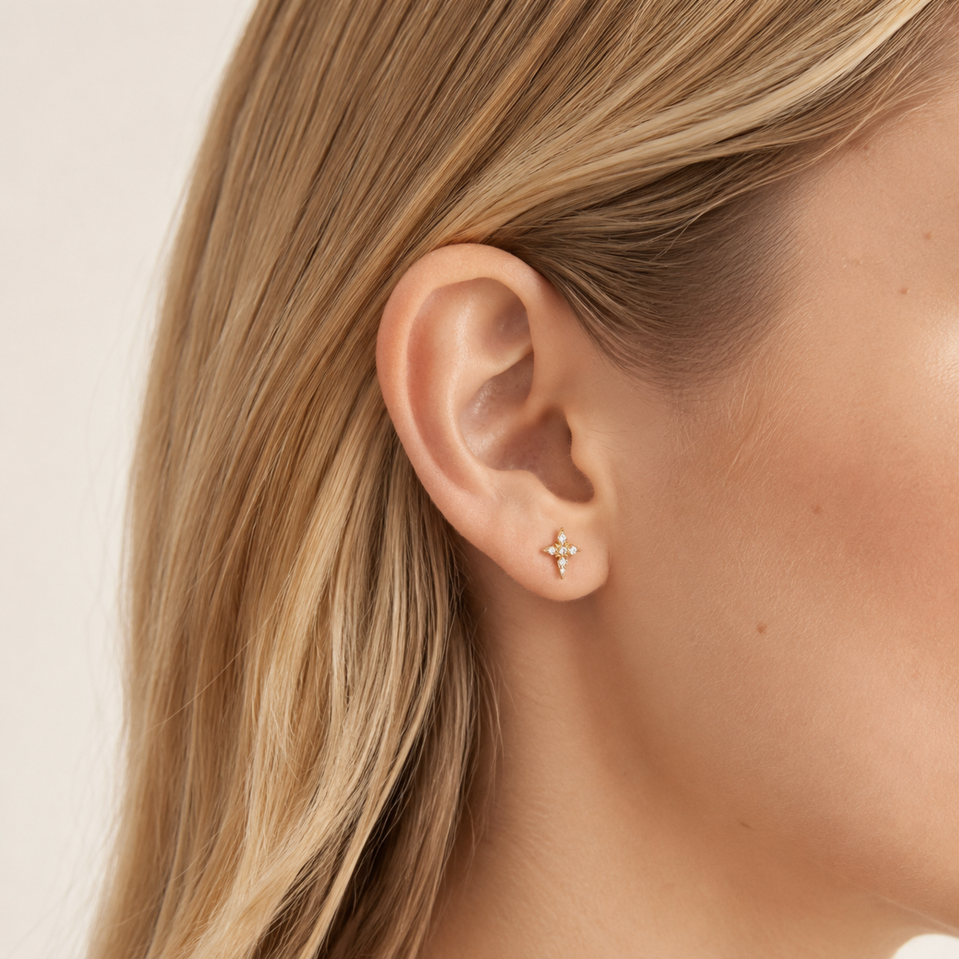 Sterling Silver Four-Point Star Zirconia Stud Earrings worn on the ear