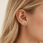 Sterling Silver Croissant Twist Stud Earrings worn on the ear