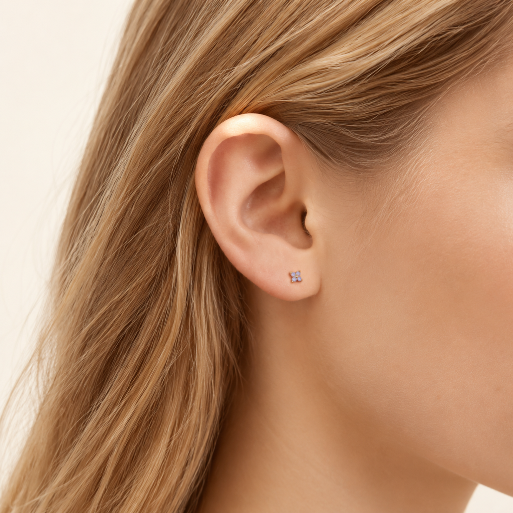 Sterling Silver Blue Zirconia Flower Stud Earrings worn on the ear